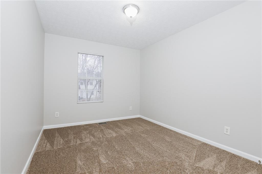 5896 Strathmoor Manor Circle Lithonia, GA 30058 - Photo 10 of 19 an empty room with a window