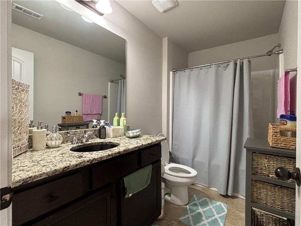3459 In Bloom Way Auburn, GA 30011 - Photo 21 of 35 a bathroom with a granite countertop sink toilet and a mirror