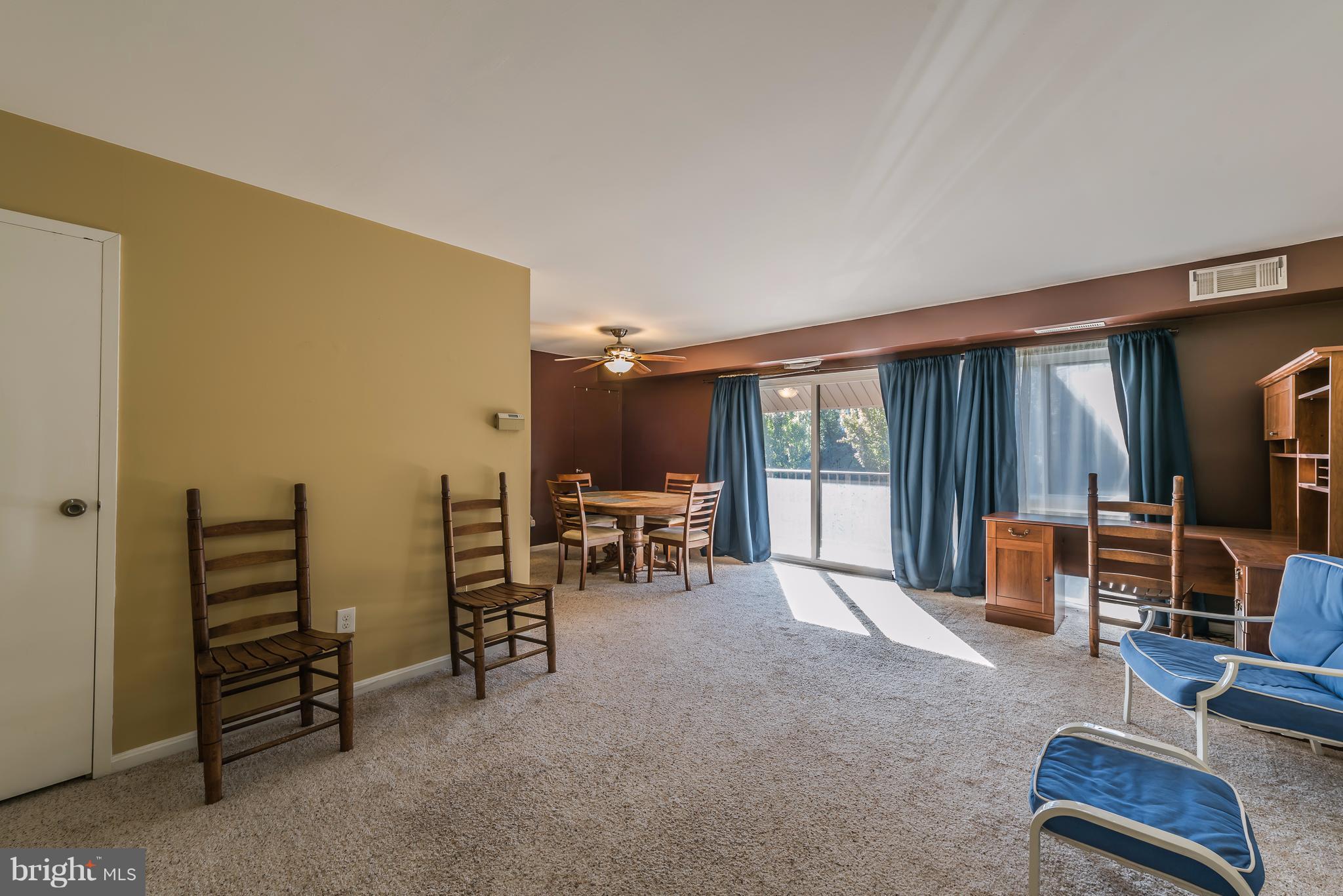 6137 Edsall Road, Unit O Alexandria, VA 22304 - Photo 2 of 13 a living room with furniture a flat screen tv and floor to ceiling window