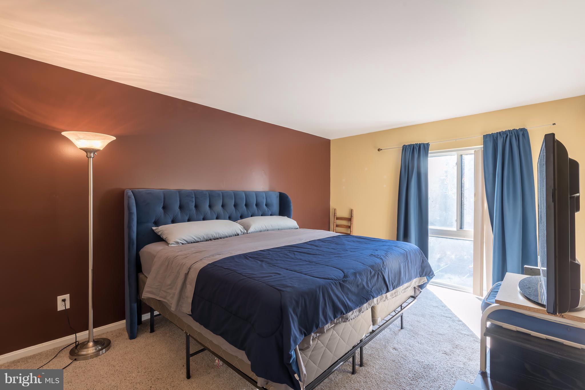 6137 Edsall Road, Unit O Alexandria, VA 22304 - Photo 12 of 13 a bedroom with a bed and a flat screen television