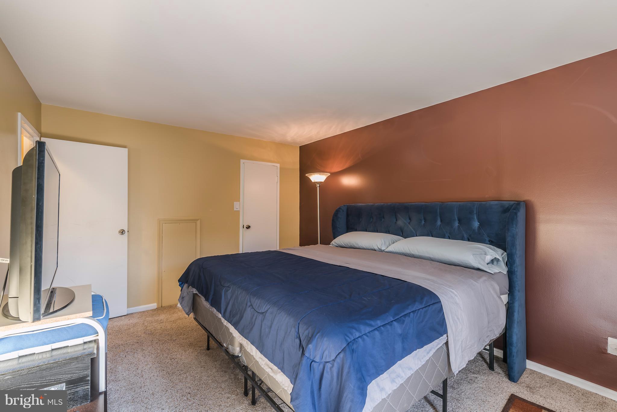 6137 Edsall Road, Unit O Alexandria, VA 22304 - Photo 13 of 13 a bedroom with a bed and a flat screen tv