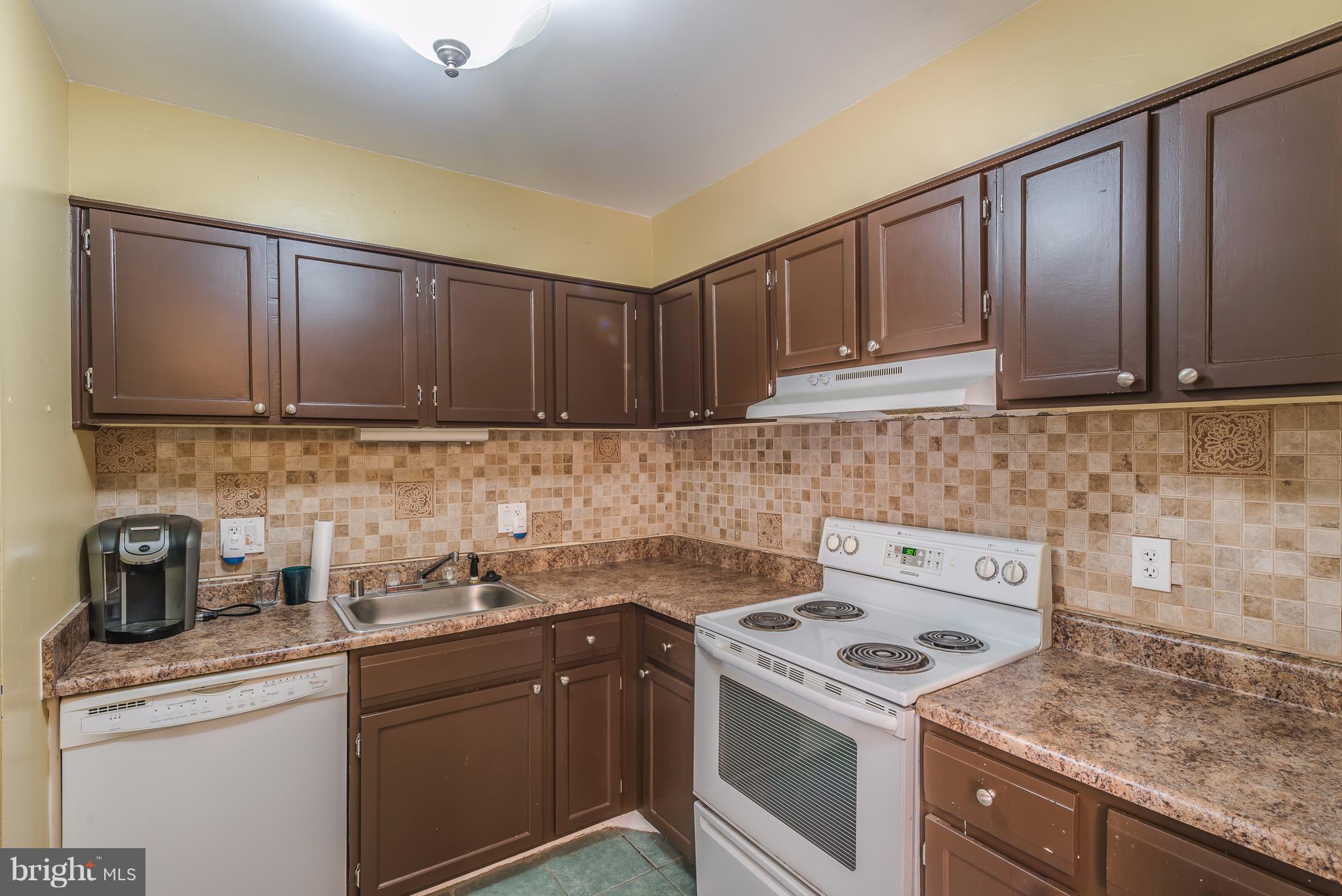 6137 Edsall Road, Unit O Alexandria, VA 22304 - Photo 8 of 13 a kitchen with a sink stove and cabinets