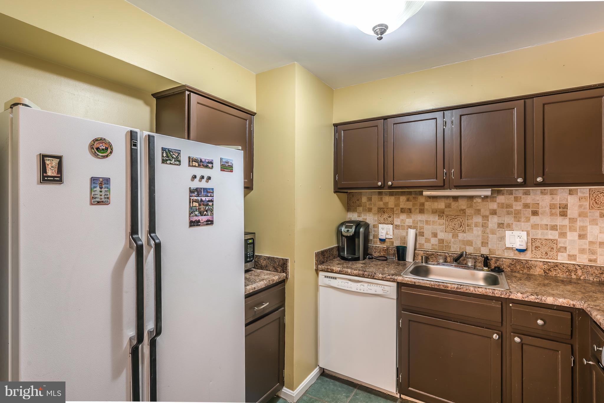 6137 Edsall Road, Unit O Alexandria, VA 22304 - Photo 9 of 13 a kitchen with stainless steel appliances granite countertop a refrigerator and a sink