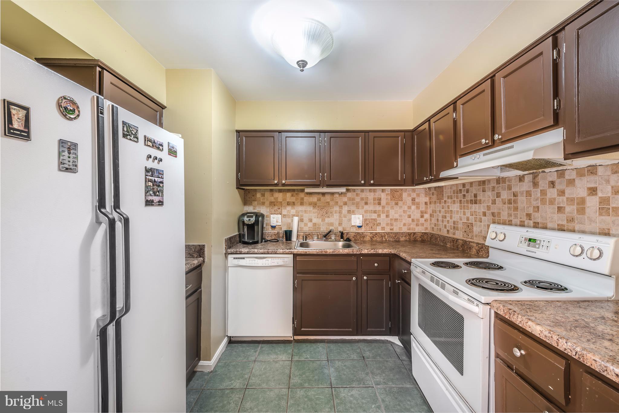 6137 Edsall Road, Unit O Alexandria, VA 22304 - Photo 10 of 13 a kitchen with stainless steel appliances granite countertop a stove a refrigerator and a sink