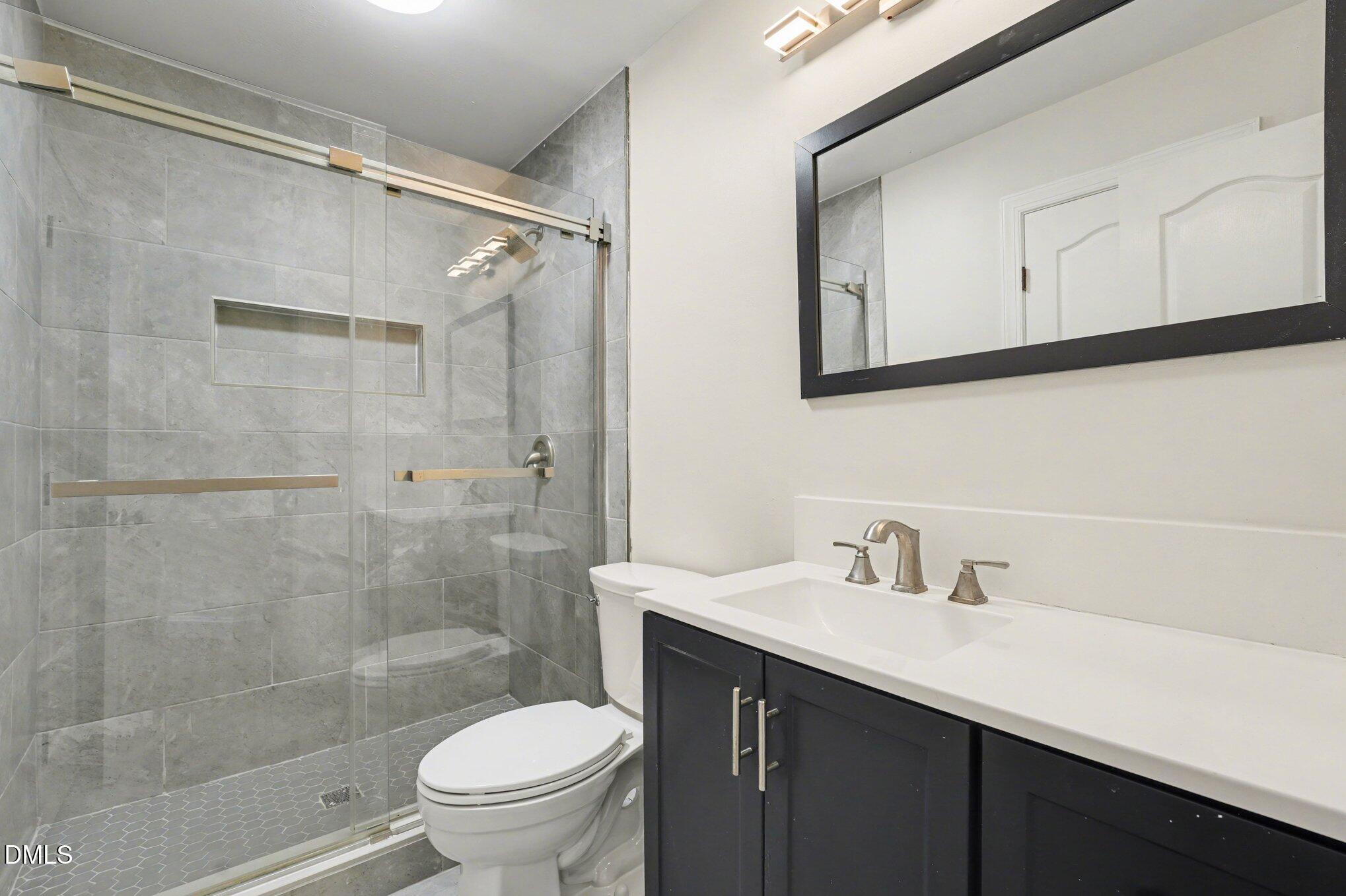 7250 Sandcastle Lane Linden, NC 28356 - Photo 11 of 20 a bathroom with a sink a toilet and shower