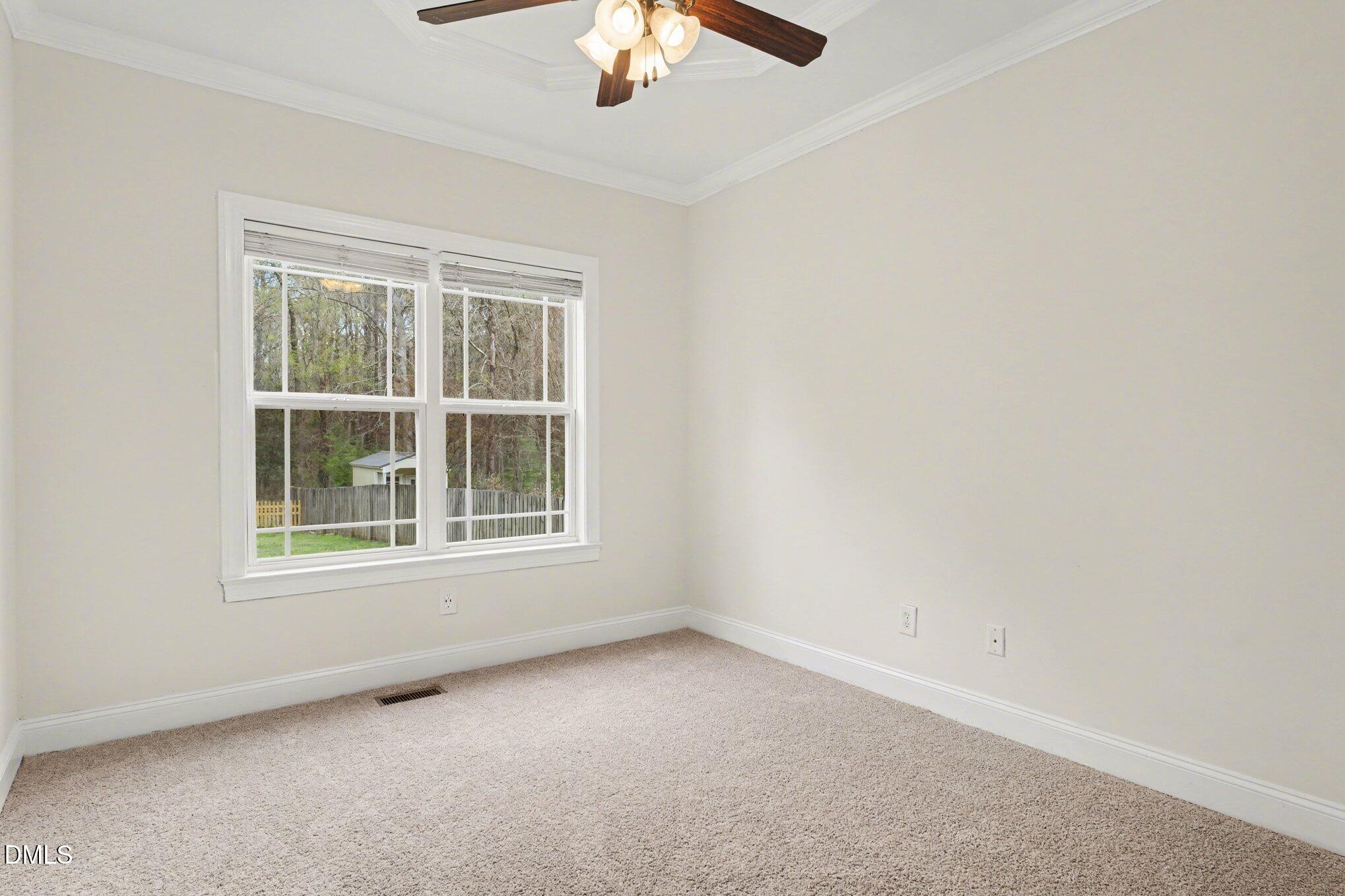 7250 Sandcastle Lane Linden, NC 28356 - Photo 14 of 20 an empty room with a window and a fan