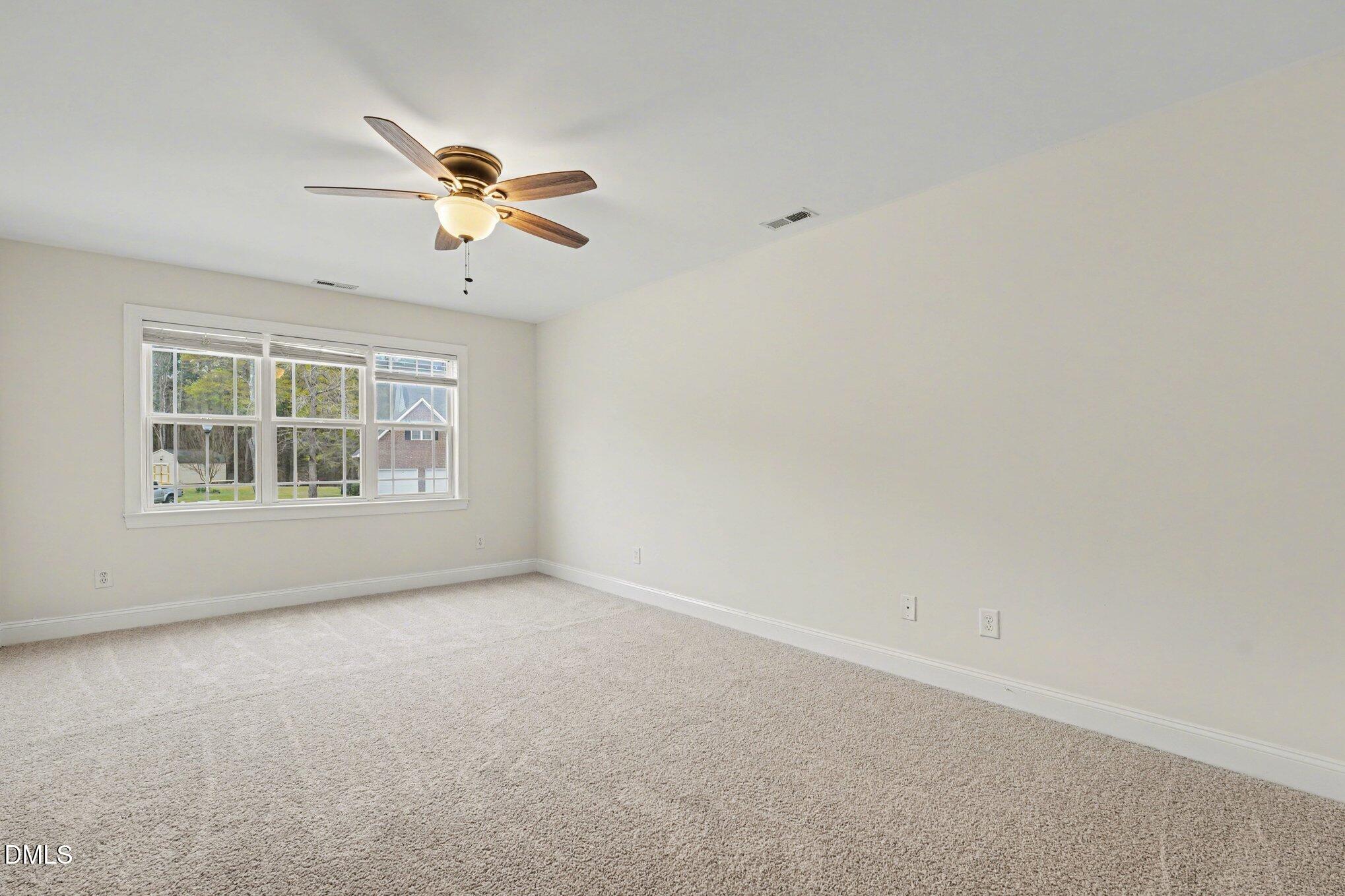7250 Sandcastle Lane Linden, NC 28356 - Photo 16 of 20 an empty room with windows and fan