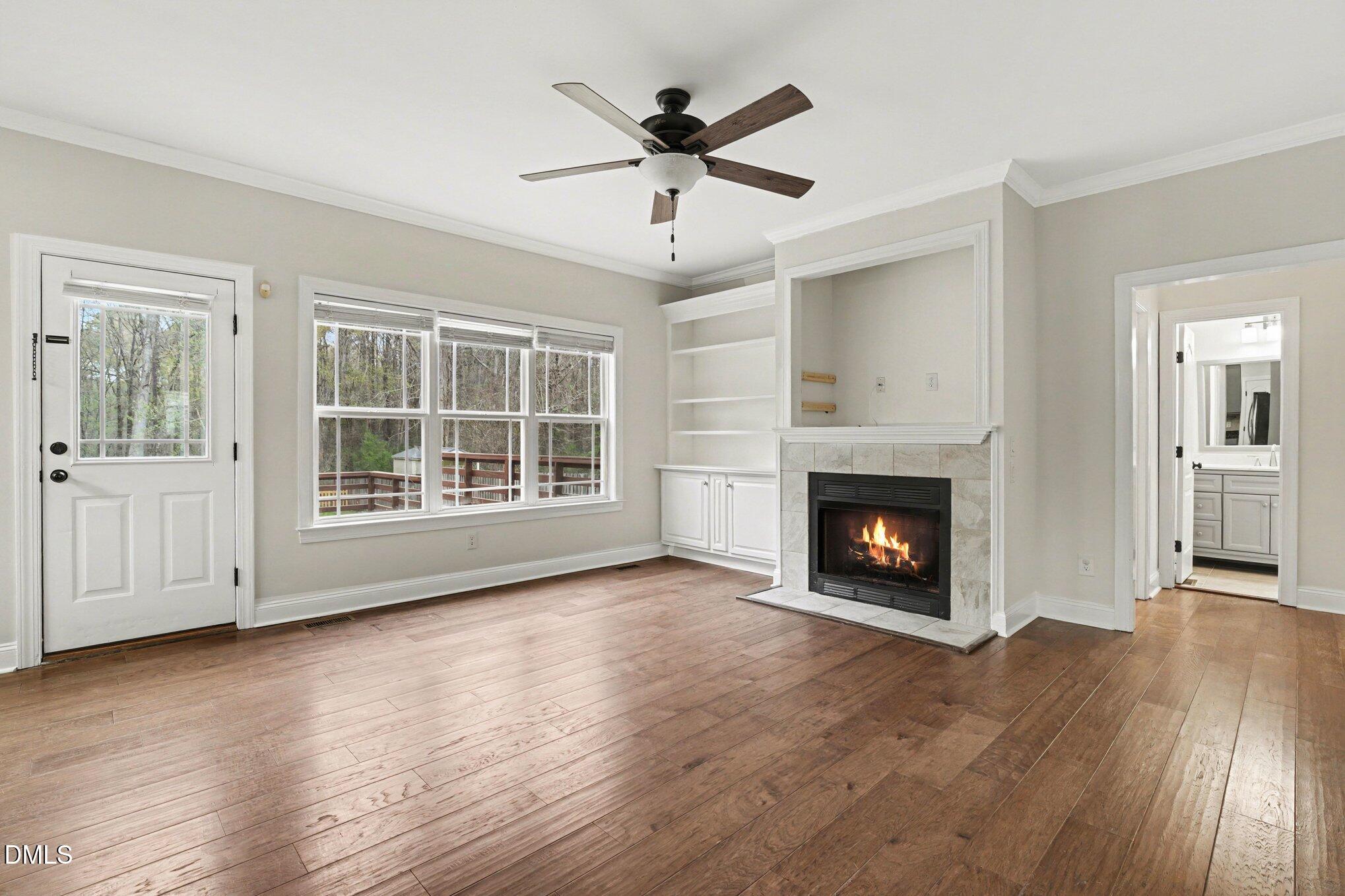 7250 Sandcastle Lane Linden, NC 28356 - Photo 4 of 20 wooden floor fireplace and windows in an empty room
