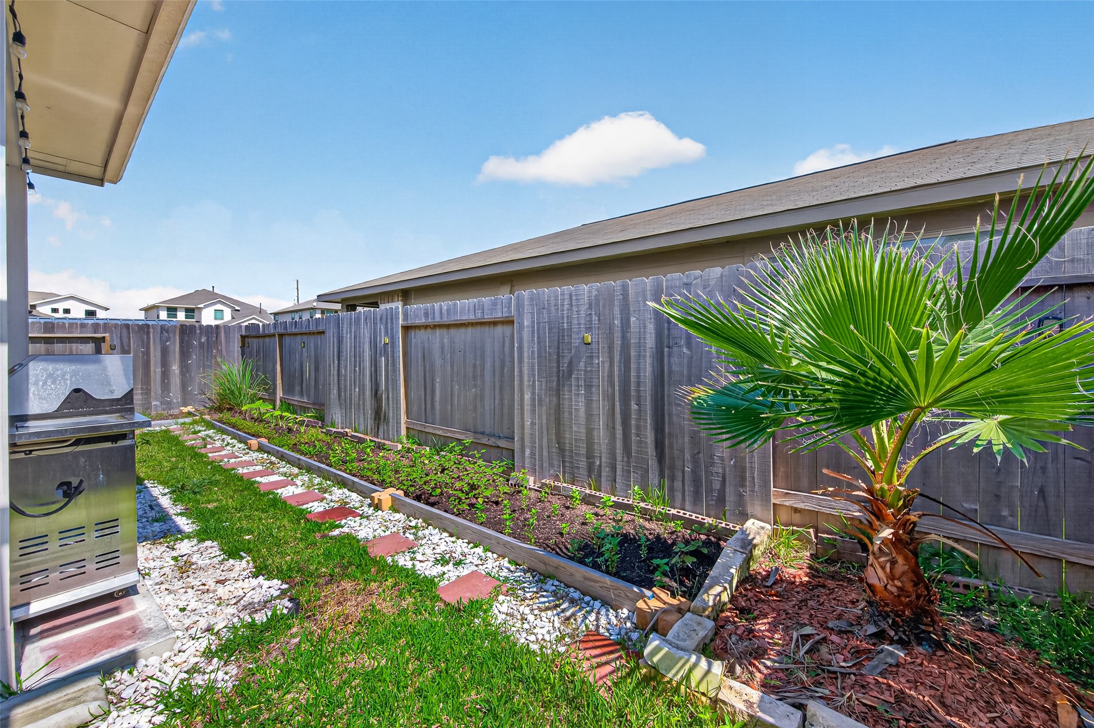 22409 Kinley Street New Caney, TX 77357 - Photo 45 of 46 a garden view with a seating space