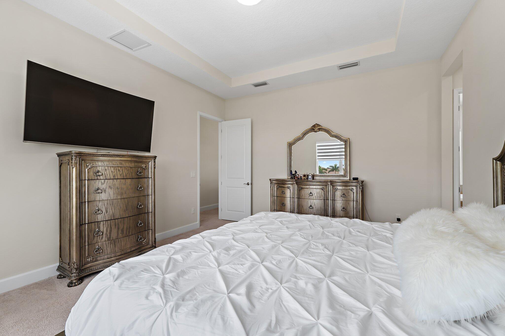15834 Hummingbird Lane Westlake, FL 33470 - Photo 28 of 61 a bed room with a bed and a television