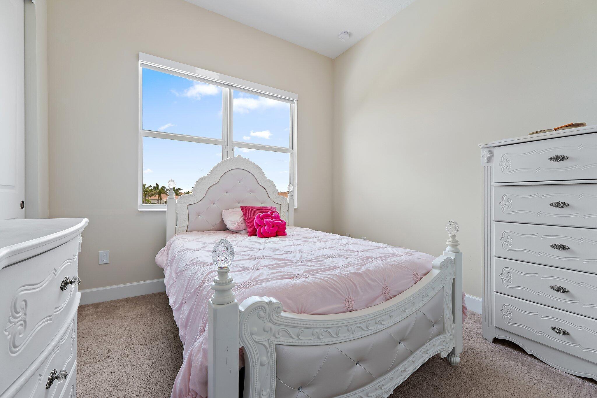 15834 Hummingbird Lane Westlake, FL 33470 - Photo 35 of 61 a bedroom with a bed and a window