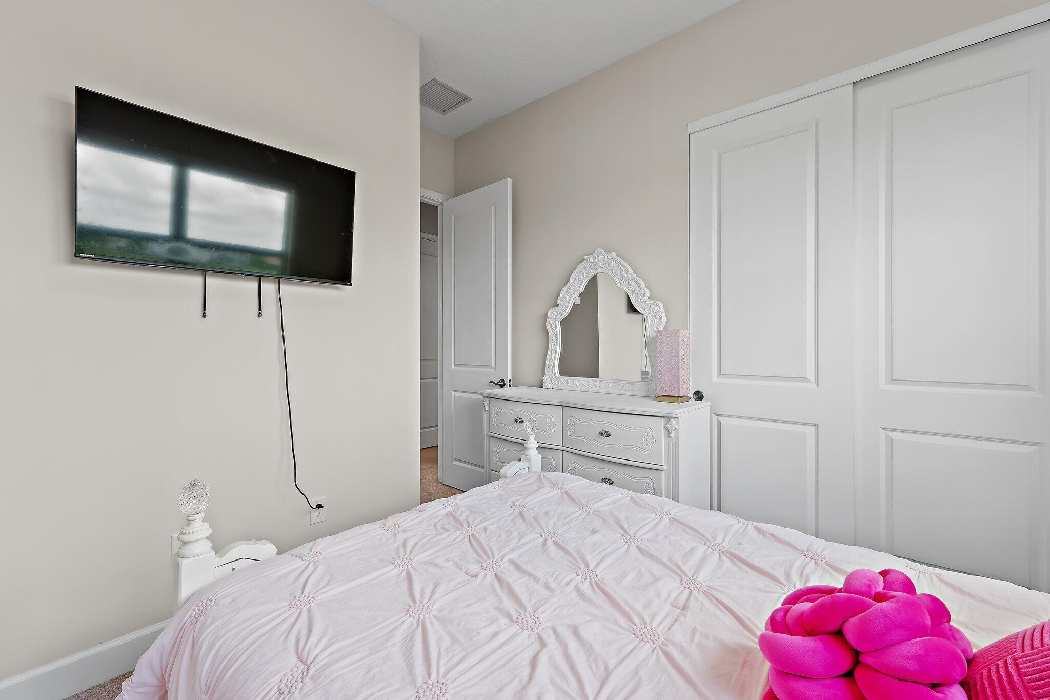 15834 Hummingbird Lane Westlake, FL 33470 - Photo 36 of 61 a bedroom with a bed and a flat screen tv