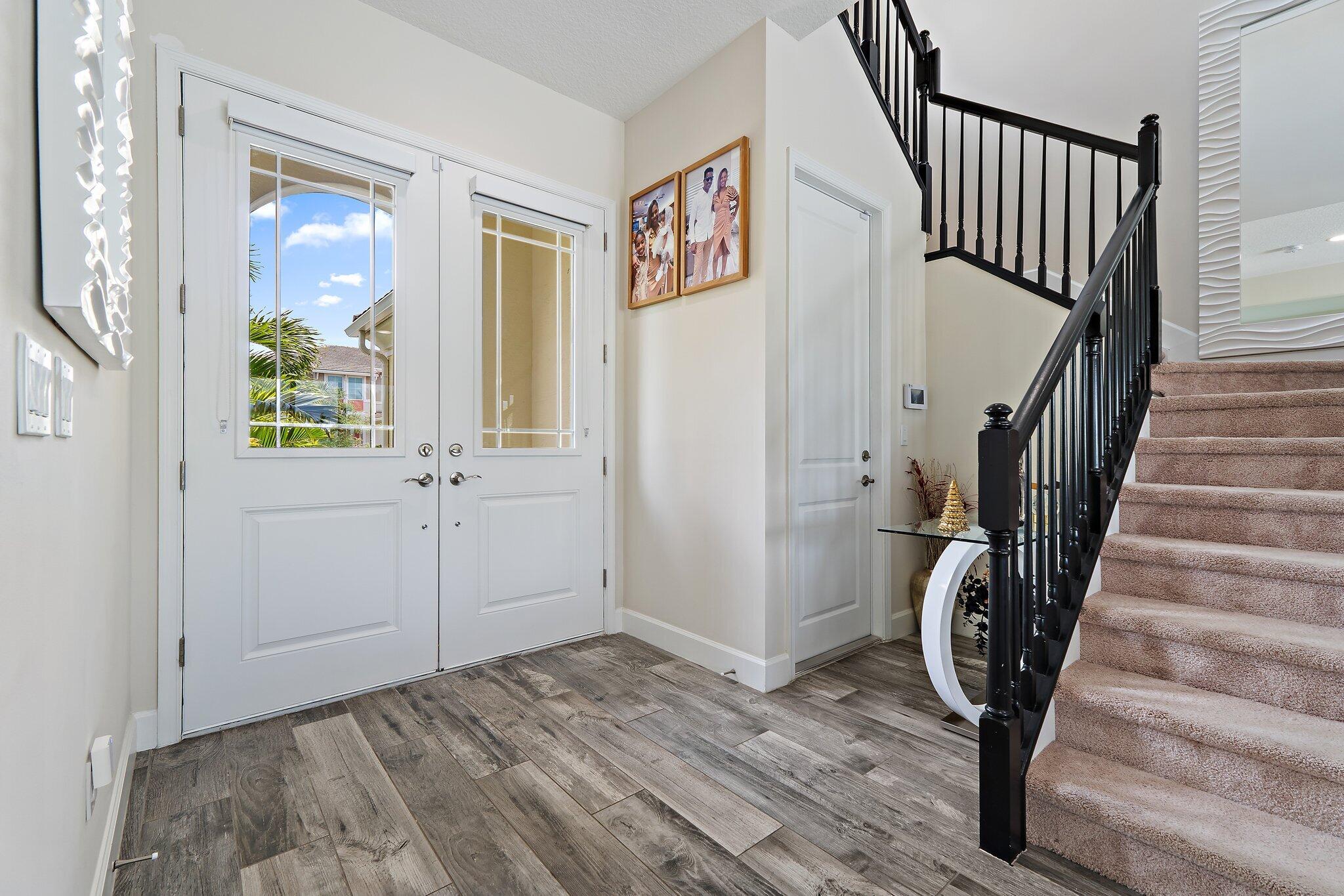 15834 Hummingbird Lane Westlake, FL 33470 - Photo 6 of 61 a view of an entryway with wooden floor and door