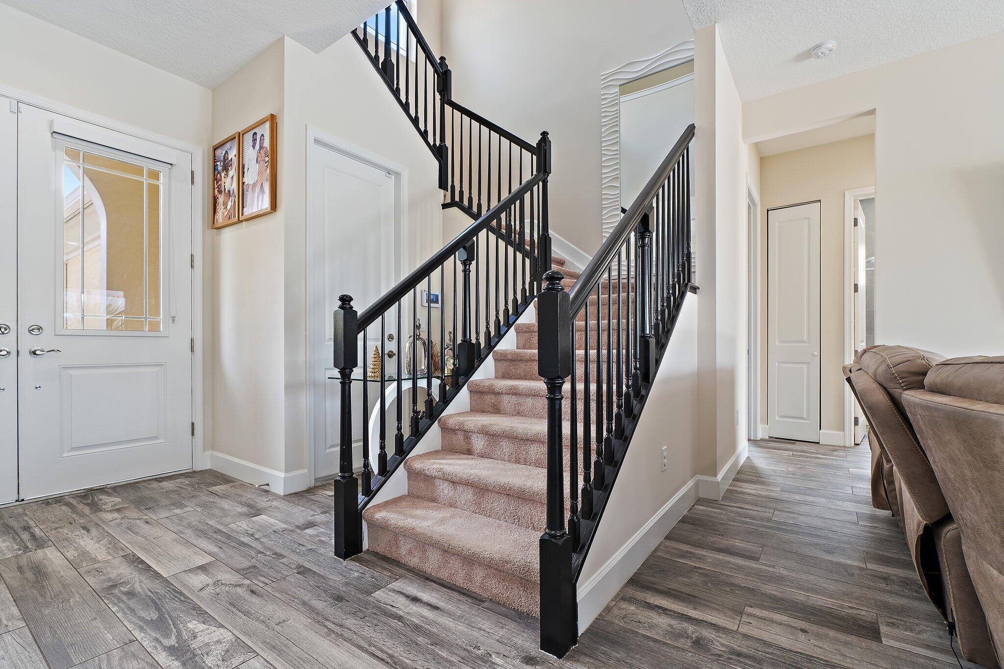 15834 Hummingbird Lane Westlake, FL 33470 - Photo 10 of 61 a view of a hallway with wooden floor and staircase