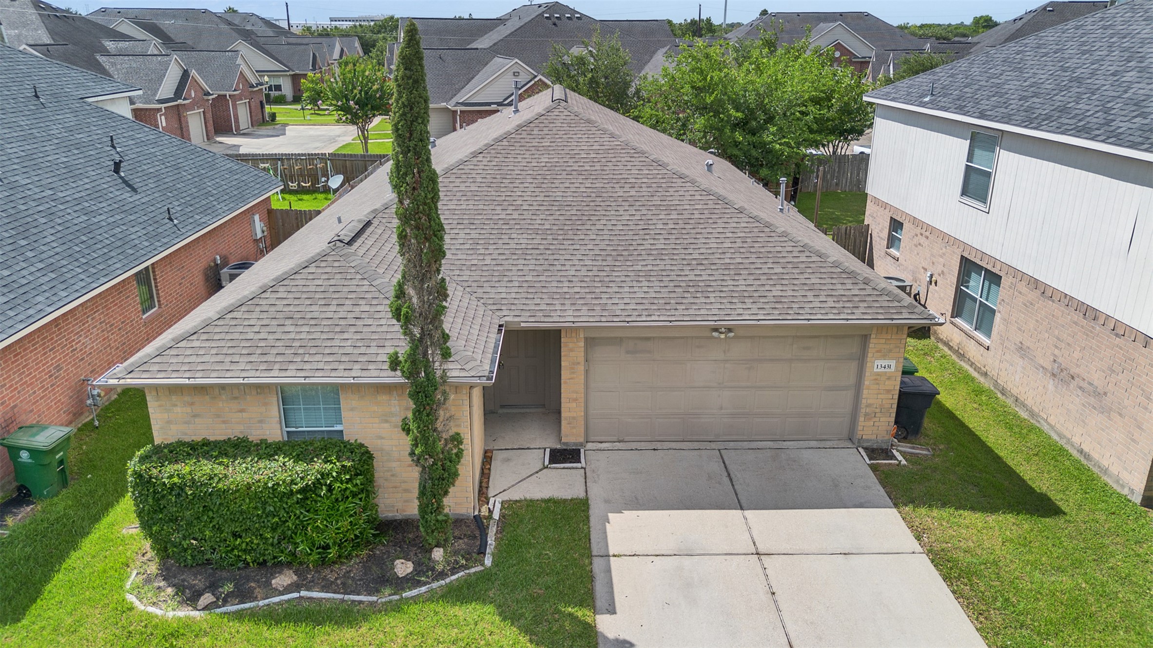 13431 Rural Oak Street Houston, TX 77034 - Photo 2 of 24 a front view of a house with garden