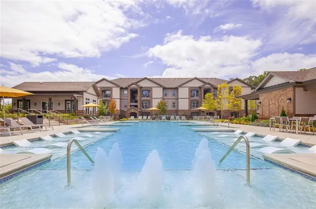 a view of residential houses with swimming pool and furniture
