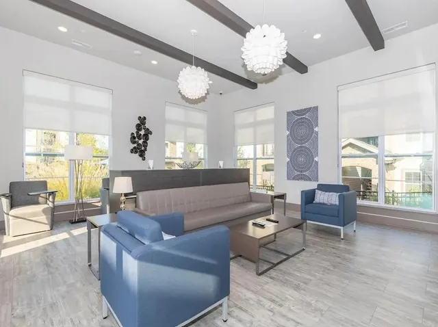 a living room with furniture dining area and a large window