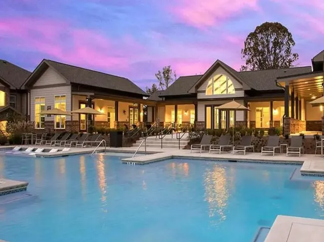 a view of a swimming pool with outdoor seating