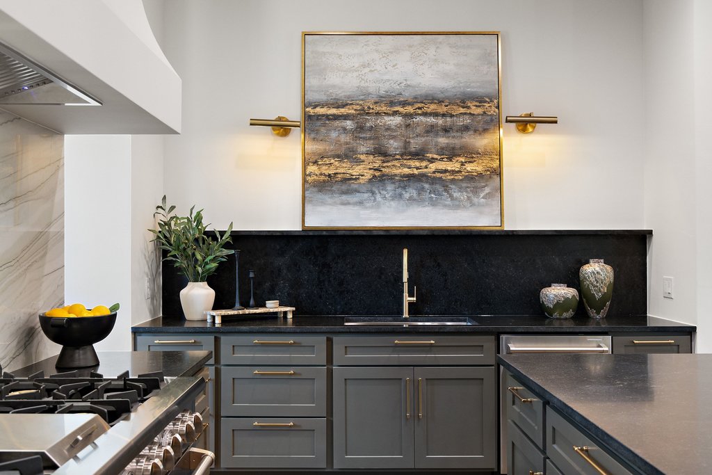 9207 Zyle Road Austin, TX 78737 - Photo 10 of 40 A refined kitchen design featuring dark cabinetry and a striking gold faucet.
