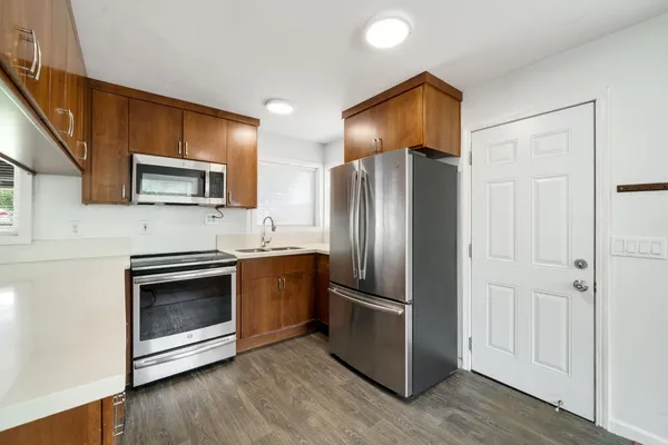 a kitchen with stainless steel appliances a refrigerator sink and stove