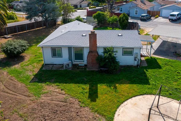 a aerial view of a house with a yard and plants