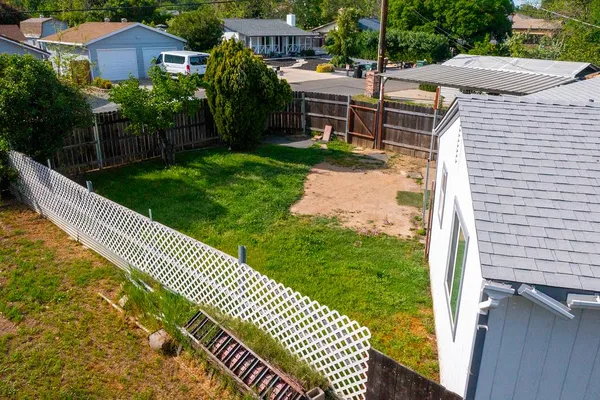 a view of a garden with wooden fence