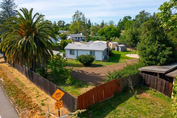 an aerial view of a house with garden space and street view