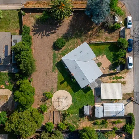 an aerial view of a house with swimming pool and outdoor space