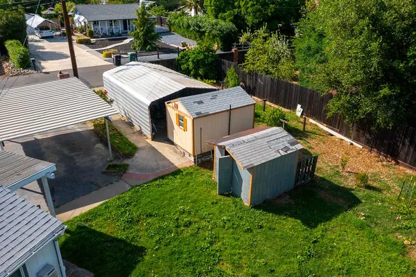 an aerial view of a house with garden space and street view