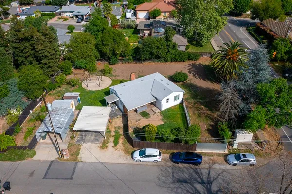 a aerial view of a house with roof deck front of house