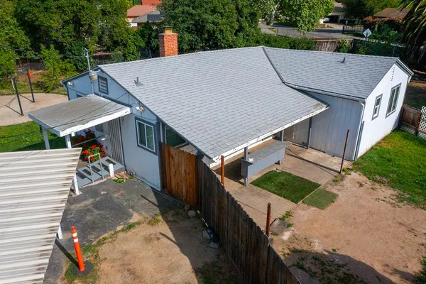 an aerial view of multiple houses with yard