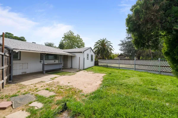 a view of a backyard with wooden fence