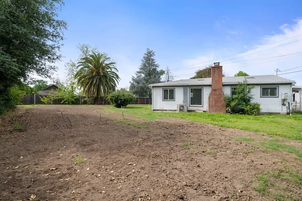 a white house sitting in middle of forest