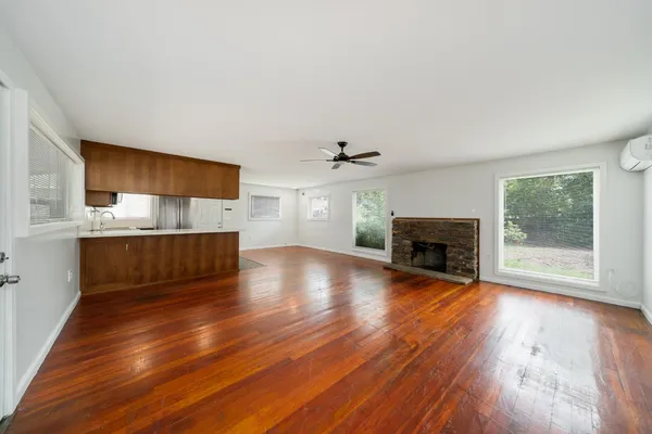 a view of empty room with wooden floor
