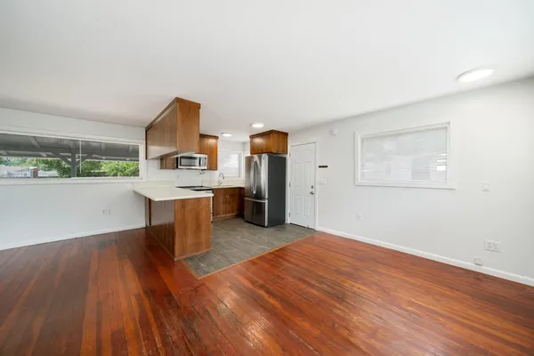 a view of a kitchen with wooden floor