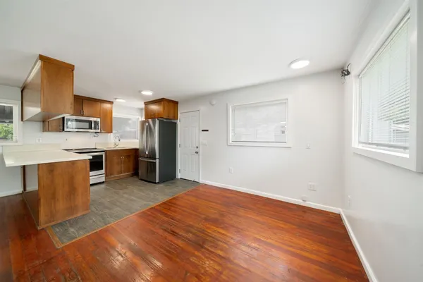 a metallic refrigerator freezer sitting in a kitchen