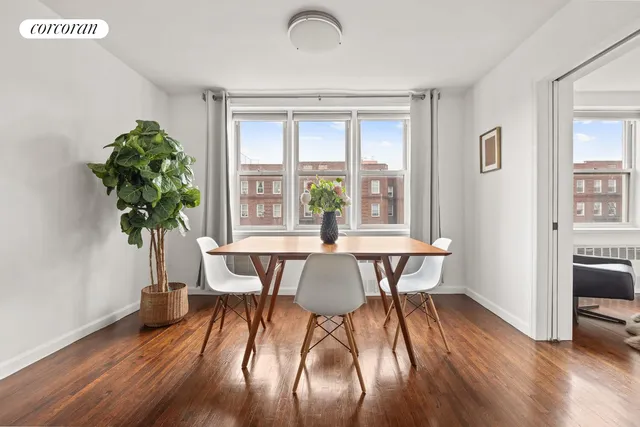 a view of a dining room with furniture window and wooden floor