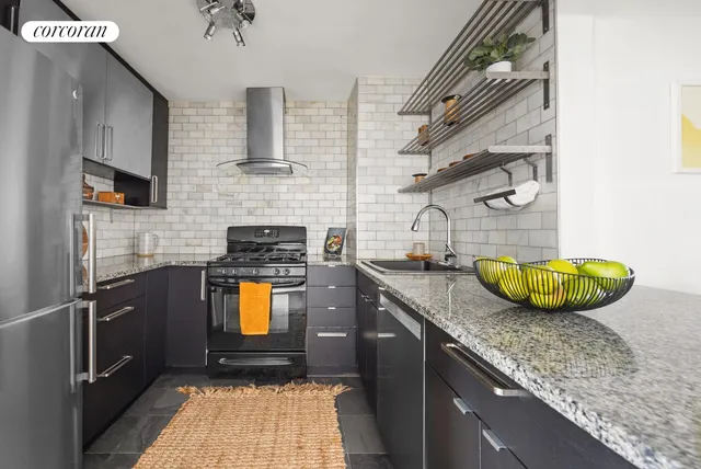 a kitchen with stainless steel appliances granite countertop a sink a stove and a microwave