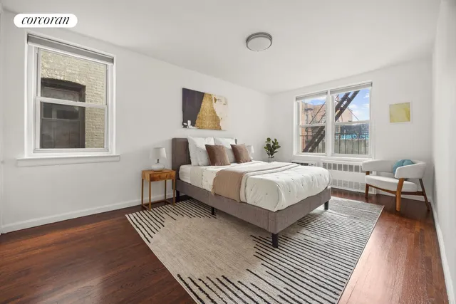 a bedroom with a bed wooden floor and window