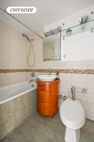 a bathroom with a sink a bath tub and shower