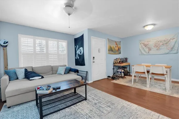 a bedroom with furniture and a wooden floor