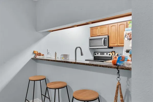a kitchen with a table chairs and a microwave