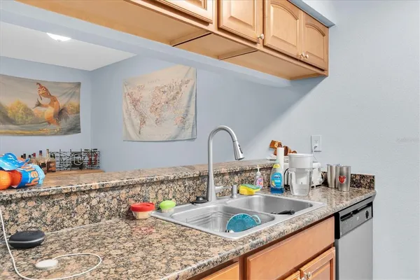 a kitchen with sink and cabinets