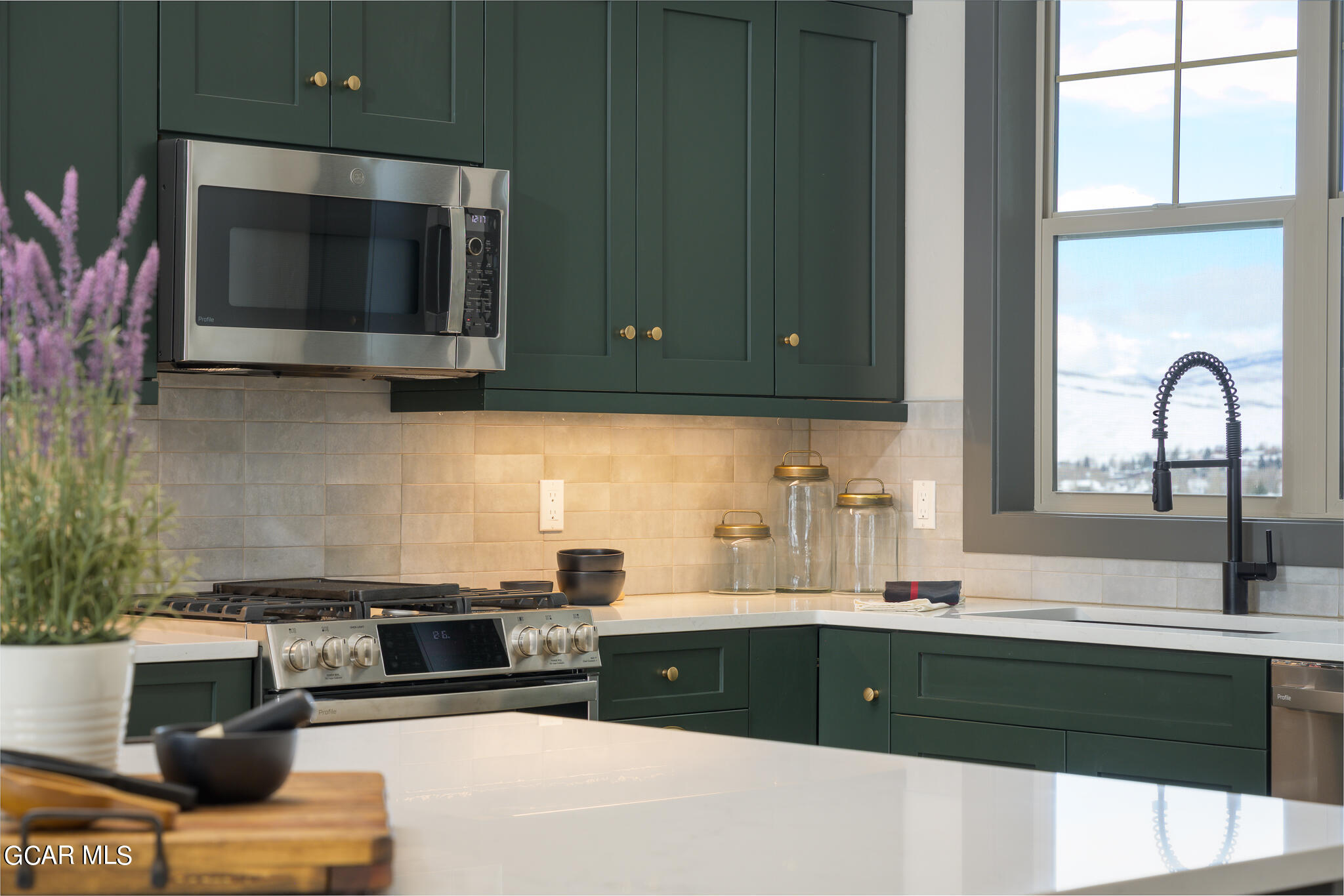 142 Eagle Ridge Drive Granby, CO 80446 - Photo 3 of 5 a kitchen with stainless steel appliances wooden cabinets and a stove top oven