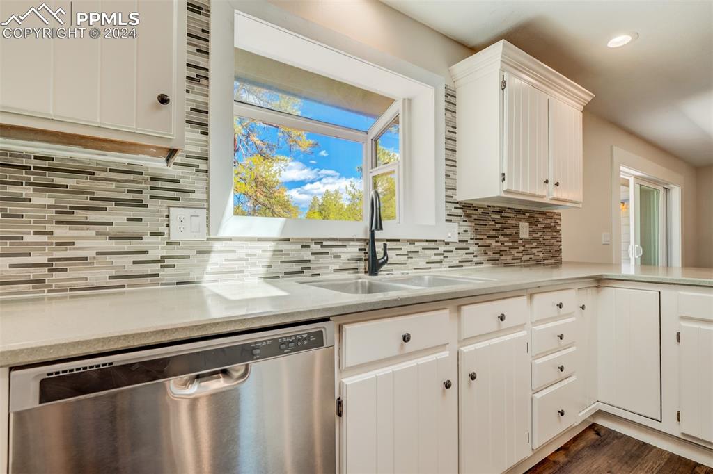 8950 Pine Cone Road Colorado Springs, CO 80908 - Photo 11 of 47 a kitchen with granite countertop white cabinets white appliances and a sink