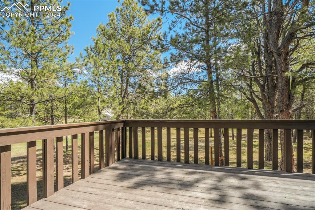 8950 Pine Cone Road Colorado Springs, CO 80908 - Photo 17 of 47 a balcony with wooden floor and fence