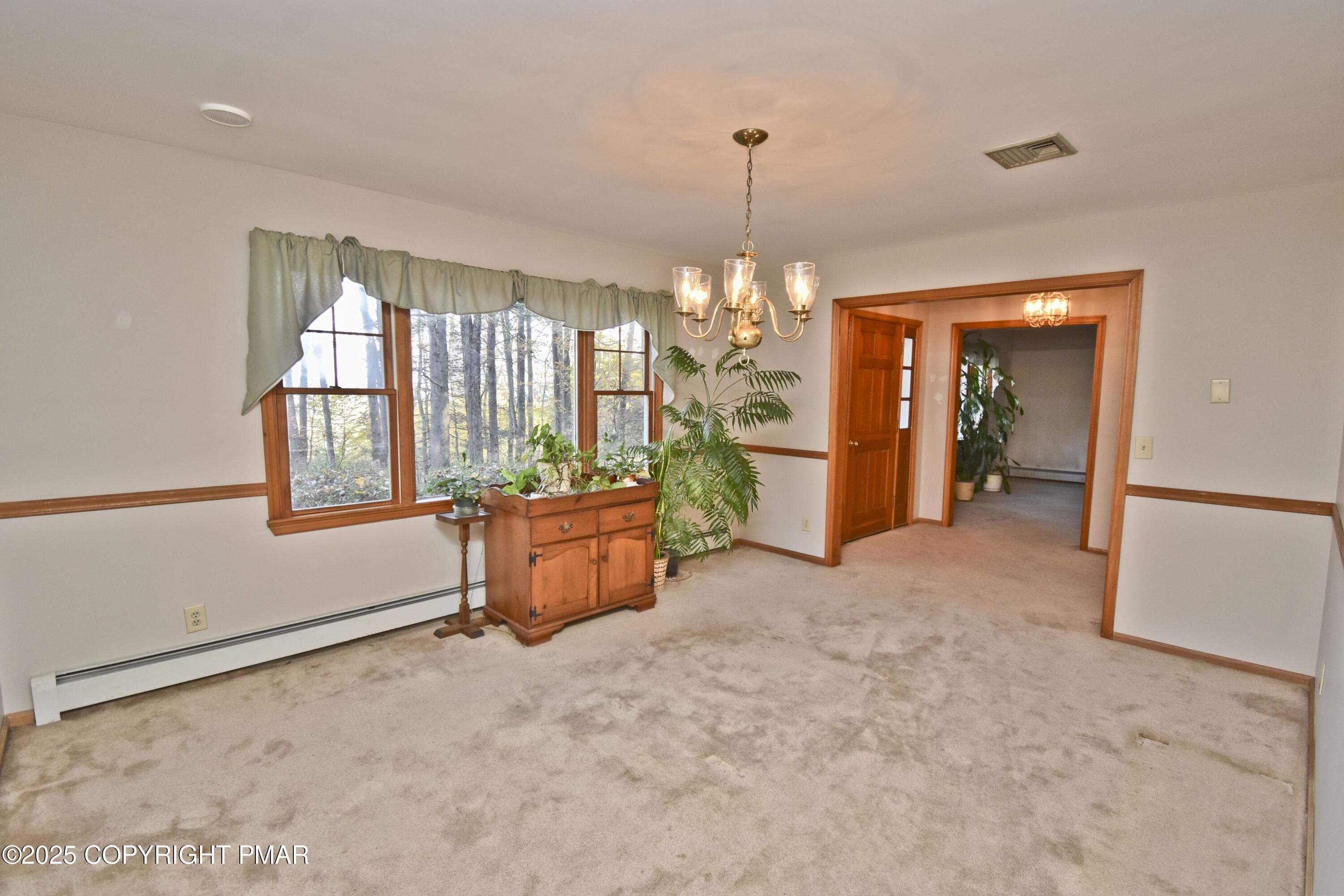 5294 Cherry Valley Road Saylorsburg, PA 18353 - Photo 19 of 53 an empty room with chandelier fan and windows