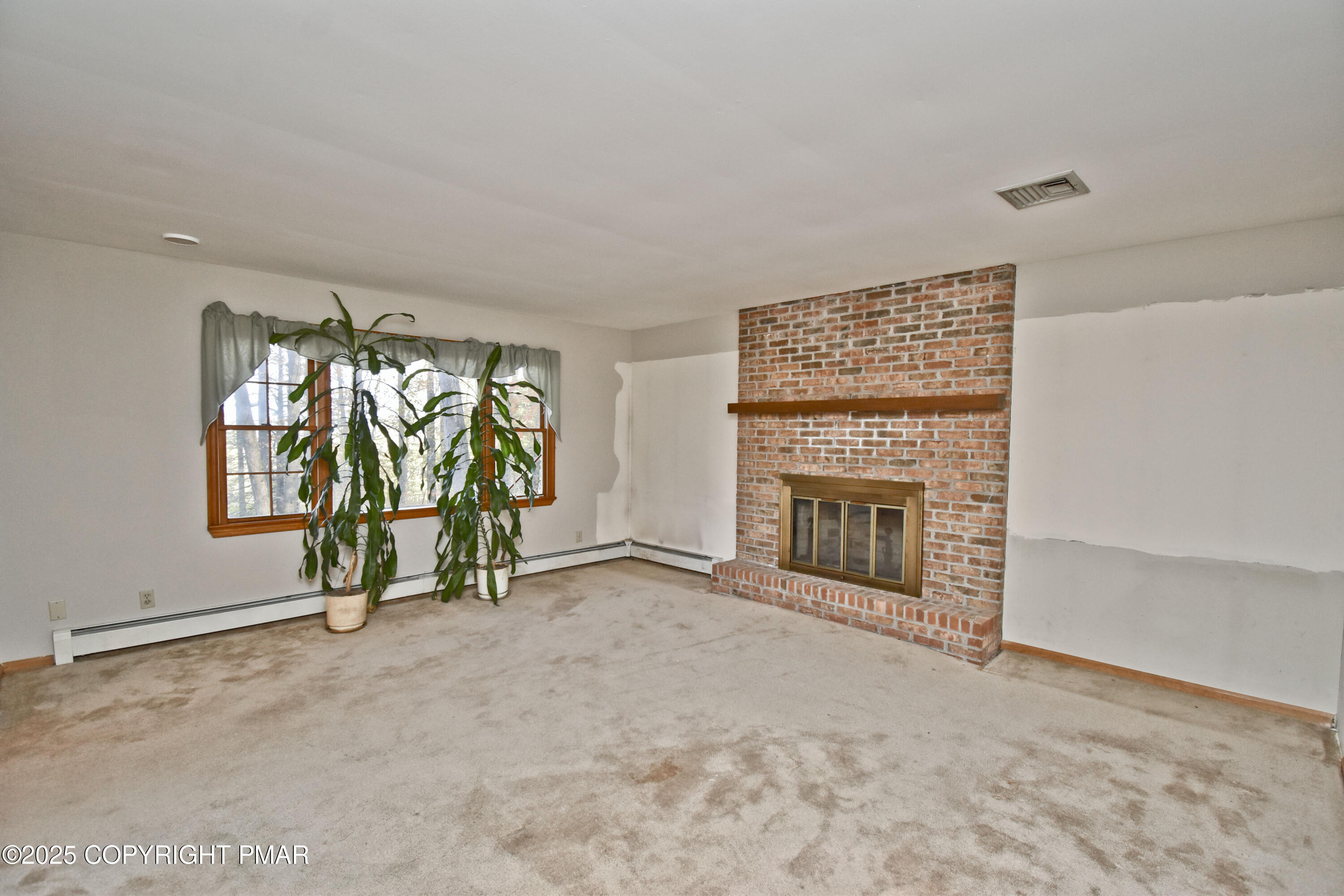 5294 Cherry Valley Road Saylorsburg, PA 18353 - Photo 24 of 53 an empty room with windows and fireplace