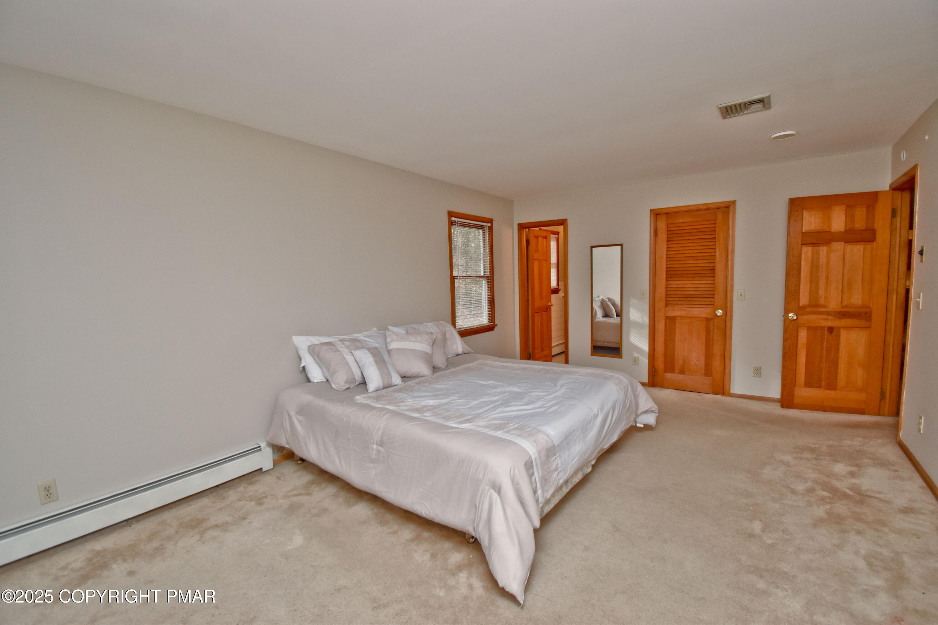 5294 Cherry Valley Road Saylorsburg, PA 18353 - Photo 27 of 53 a bedroom with a bed and large windows