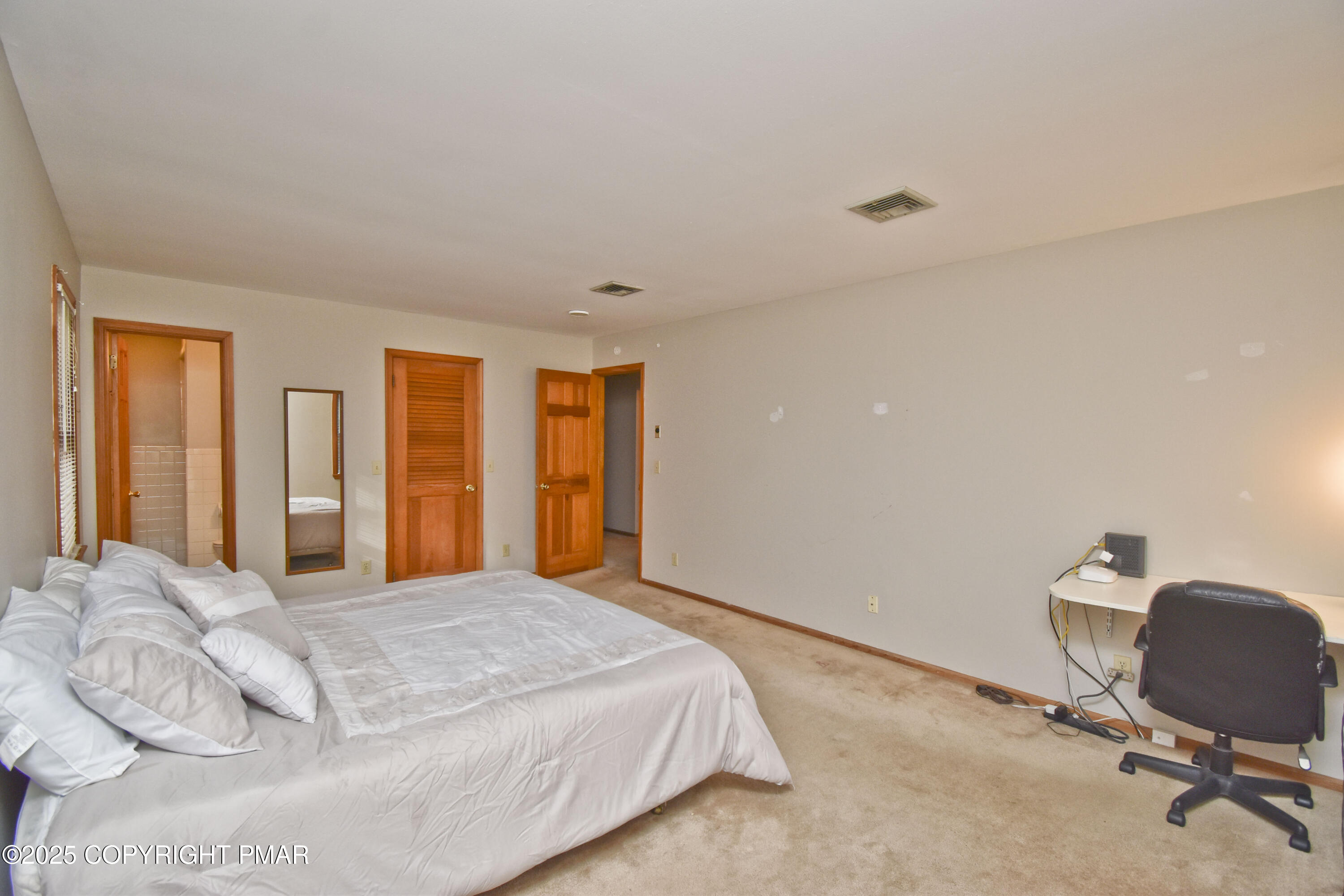 5294 Cherry Valley Road Saylorsburg, PA 18353 - Photo 28 of 53 a bedroom with a large bed and large windows